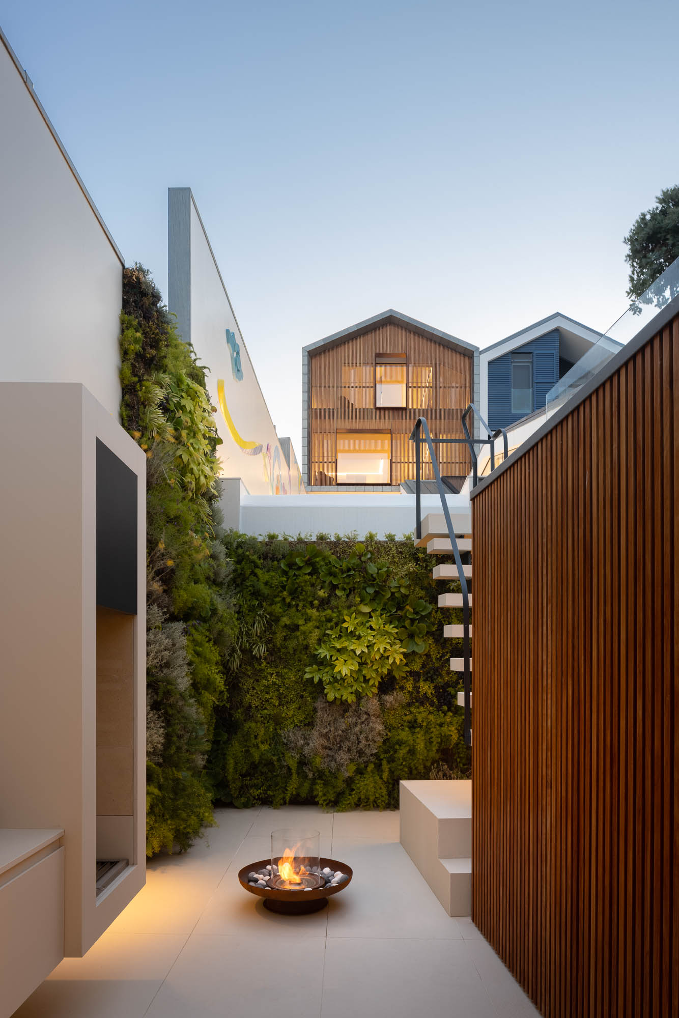 Exterior: Fachada da casa com revestimento em madeira, porta de garagem vermelha e design moderno. Arquitetura contemporânea. — Casa Costa Nova arquitetura Espaço Objecto em Ílhavo