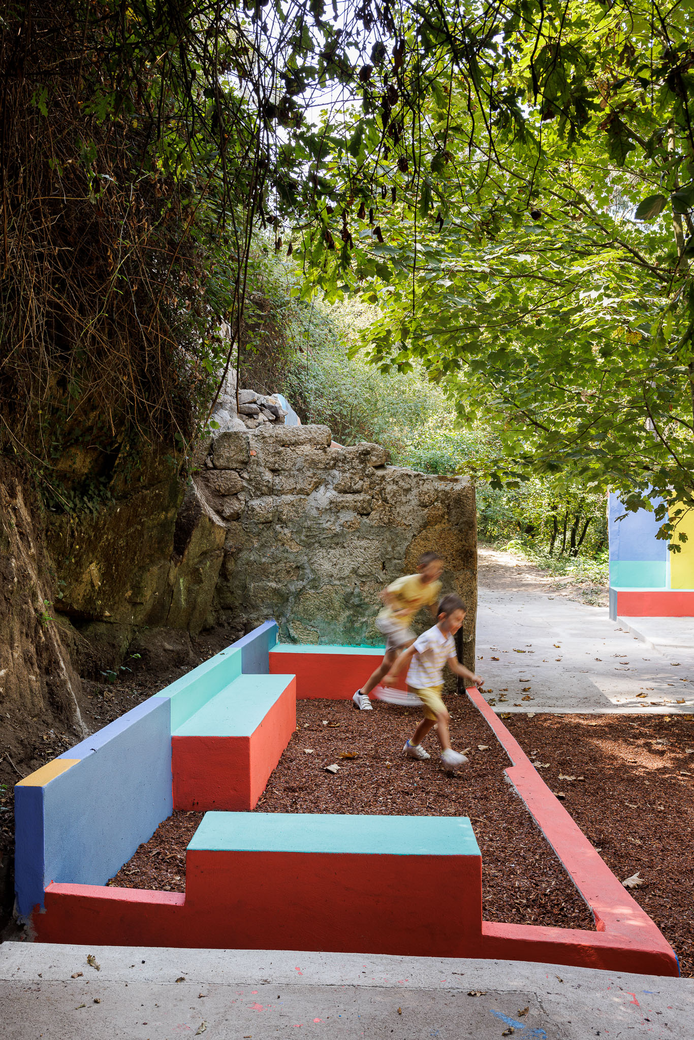 Espaço de lazer: Bancos coloridos em betão pintado, num parque com pavimento de madeira lascada. — Caminho das Escadinhas arquitetura Paulo Moreira Architectures e verkron em Matosinhos