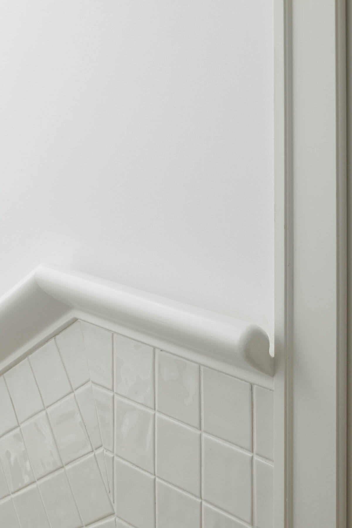 Escadas: Detalhe de azulejo branco e rodapé arredondado nas escadas. — Villa Chiado arquitetura Pedro Carrilho Arquitectos em Lisboa
