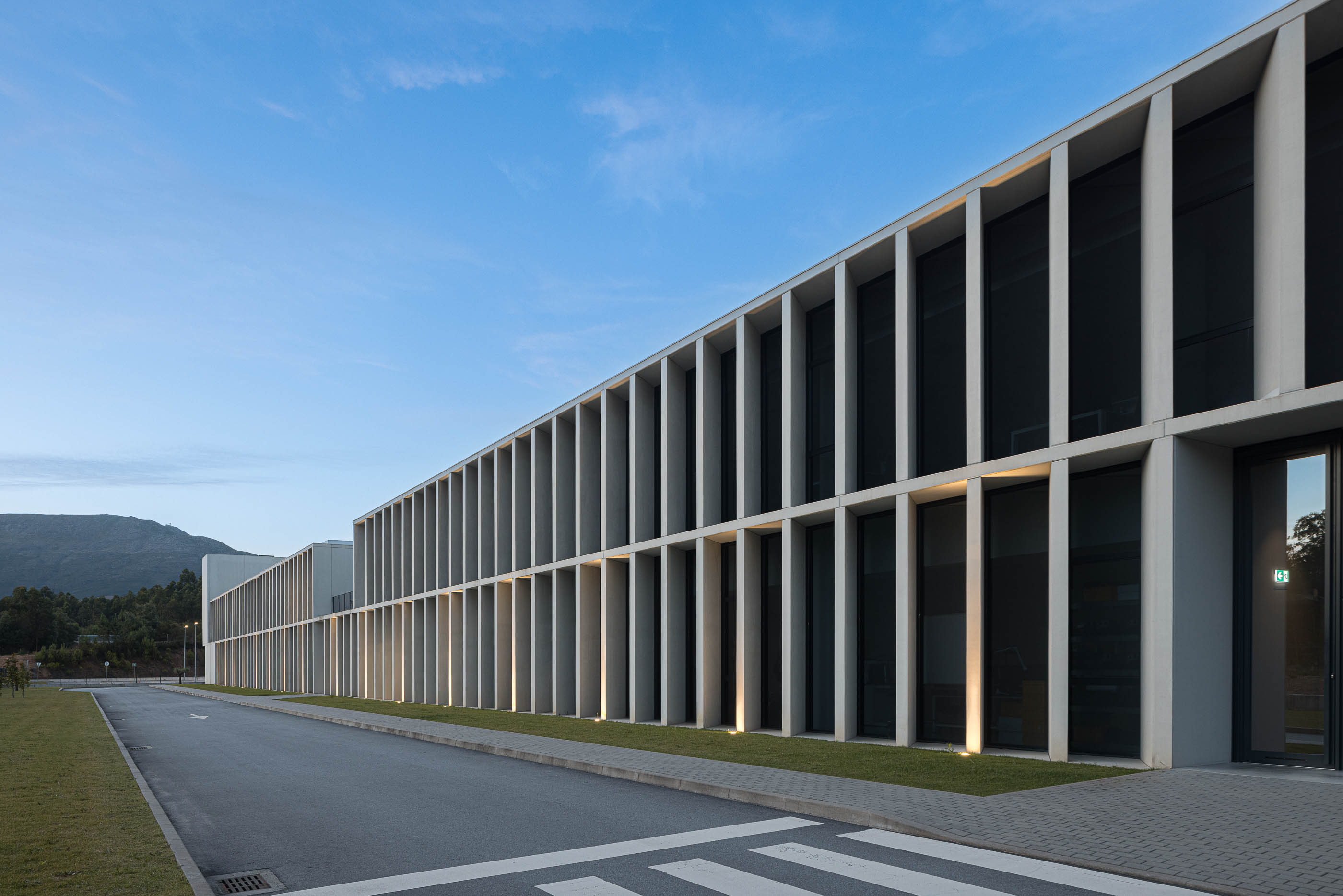 Exterior: Fachada do edifício industrial com colunas de betão e janelas amplas. — BW II – Edifício Industrial em Viana do Castelo arquitetura Multiprojectus em Viana do Castelo