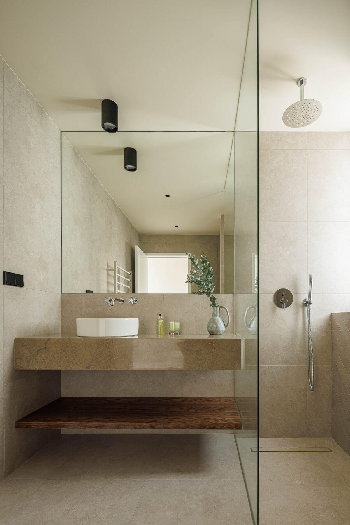 Casa de banho: Lavatório com espelho amplo e cabine de duche com revestimento cerâmico. — Parada das Estrelas arquitetura Solano Soto Architecture Studio em Óbidos