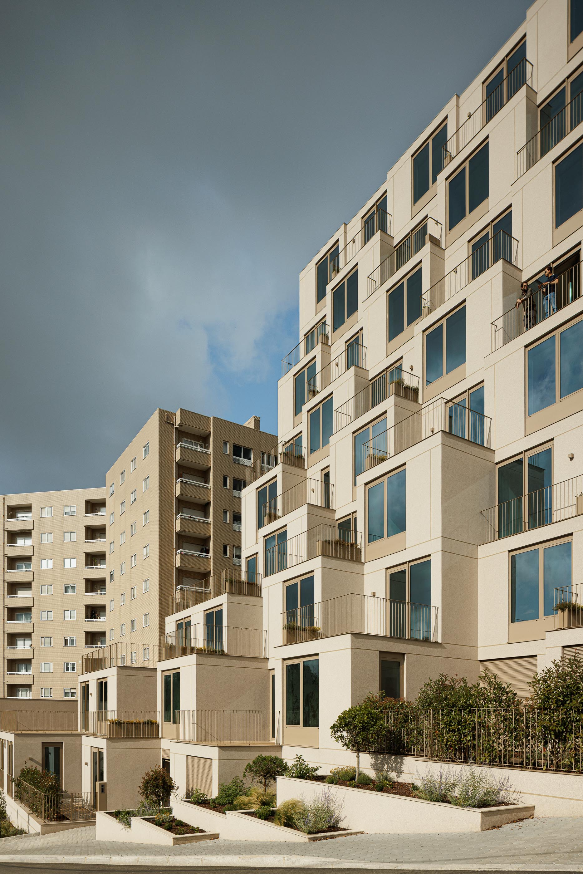 Fachada: Edifício de apartamentos com varandas escalonadas, fachada bege texturada e caixilharias castanhas. — Macau Valley arquitetura hori-zonte em Vila Nova de Gaia