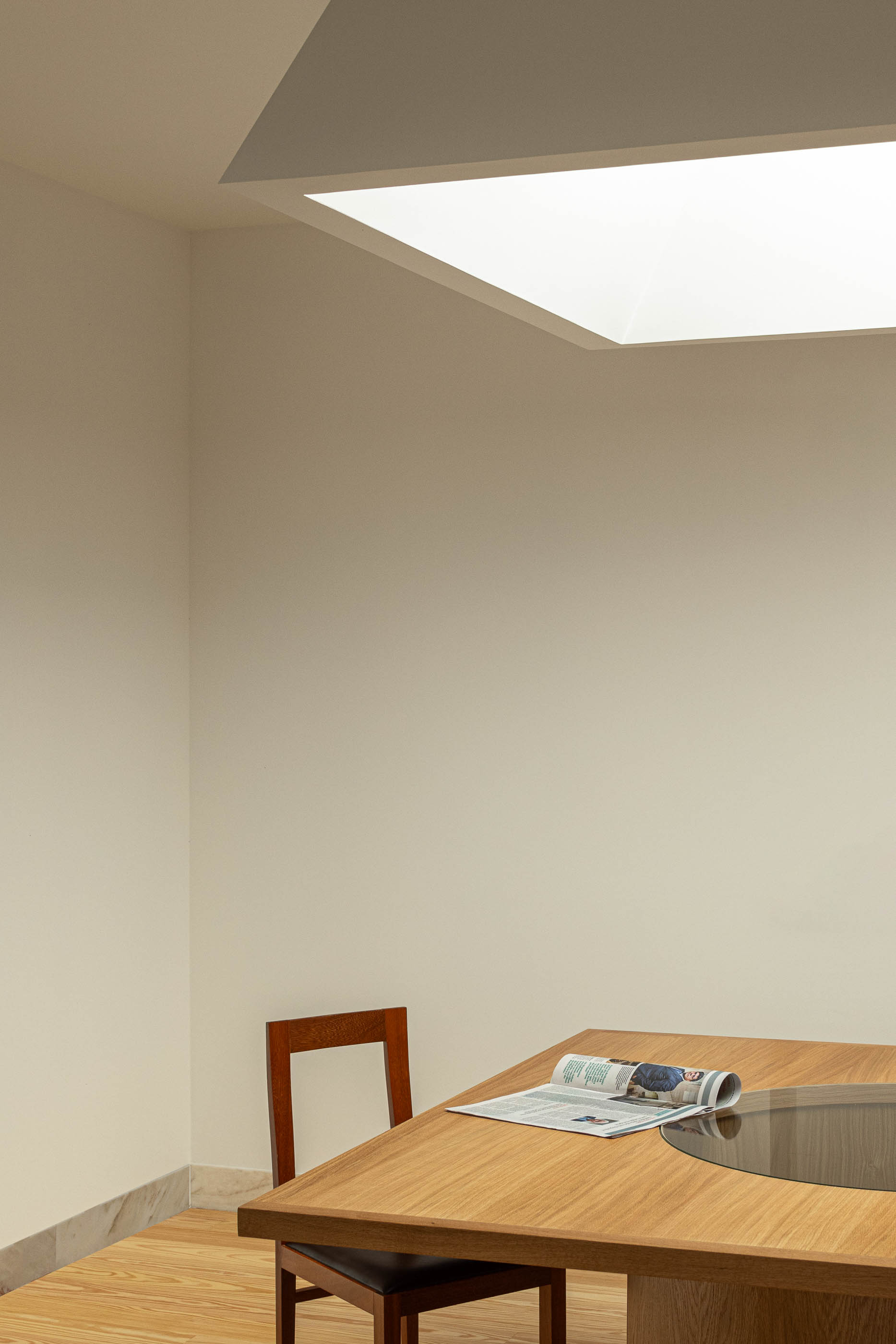 Detalhe de cadeira de madeira junto à mesa de madeira na sala de reuniões. Pavimento em madeira. — Reconversão do Talho Central arquitetura José Pedro Lima Arquiteto em Coimbra