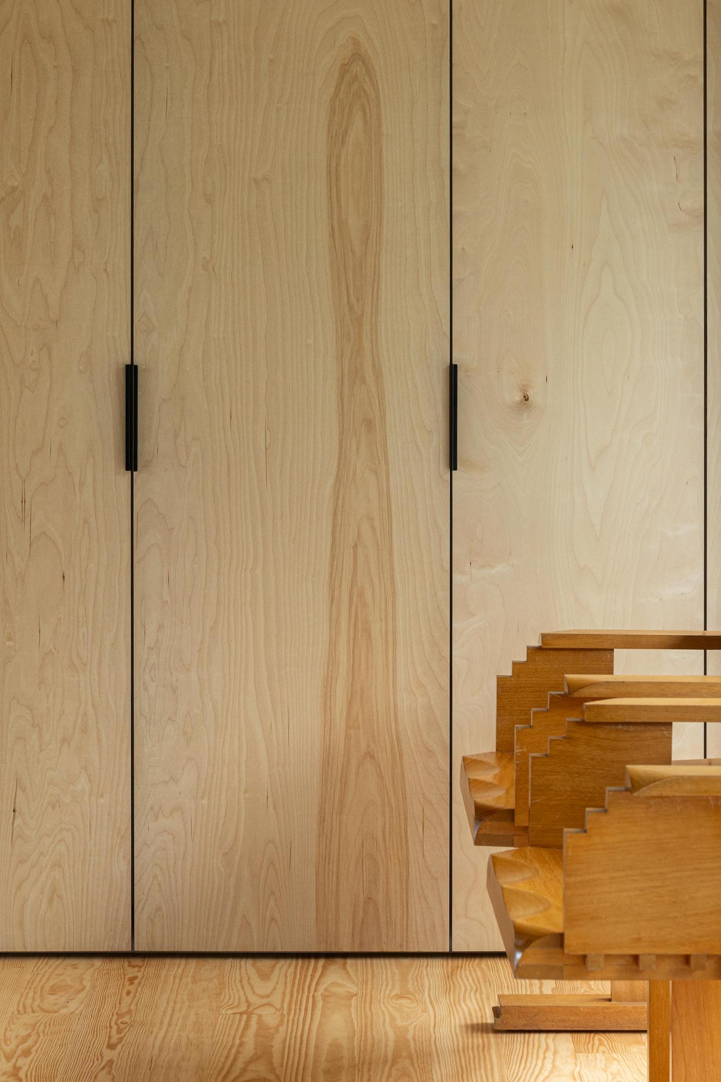 Detalhe: Roupeiro em contraplacado e cadeira de madeira. — Casa CR arquitetura SO Arquitetura & Design em São Miguel