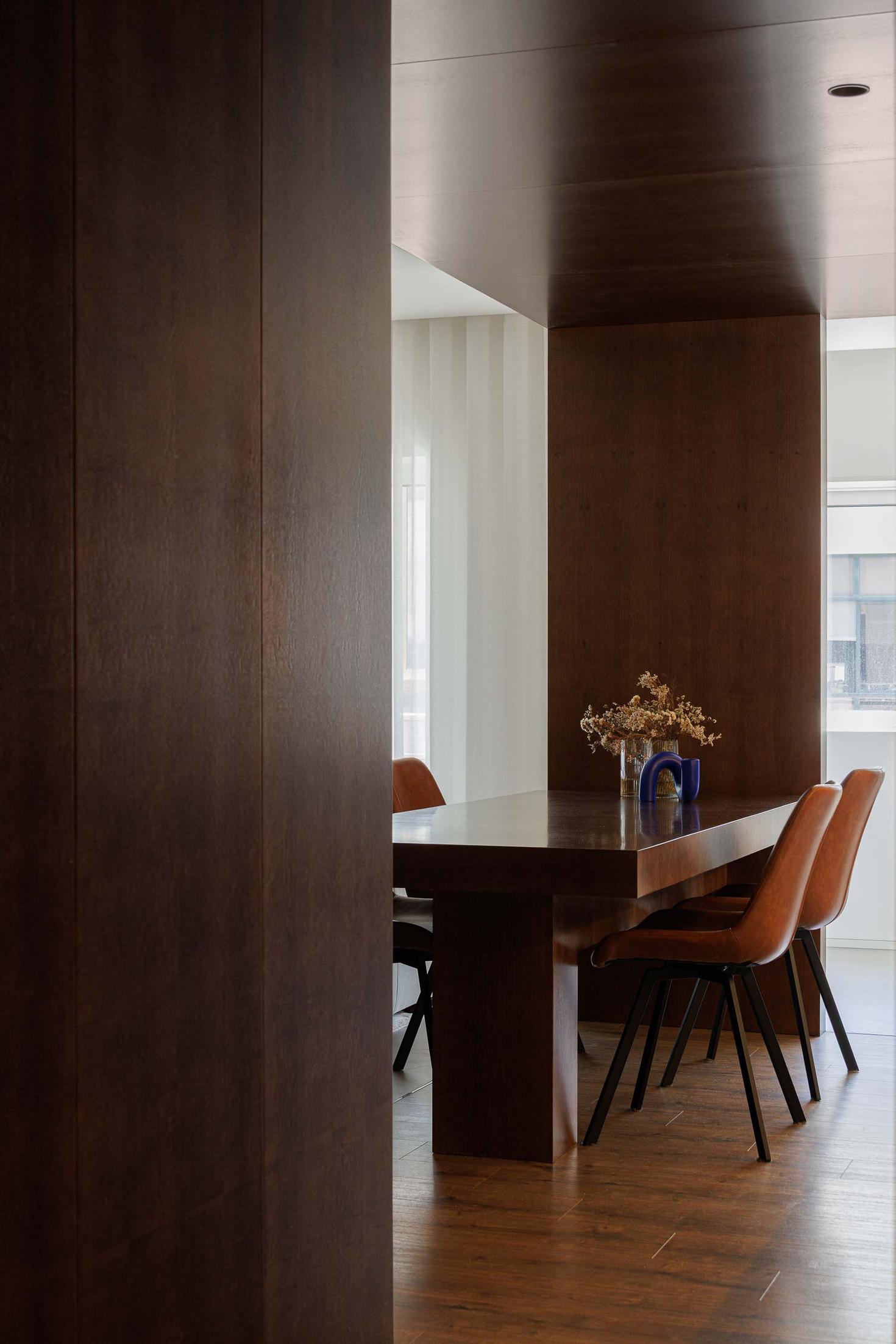Sala de estar/Sala de jantar: Mesa de madeira escura com cadeiras em pele castanha. Sofá branco ao fundo. — APARTAMENTO FP arquitetura ArquitectosRT em Braga
