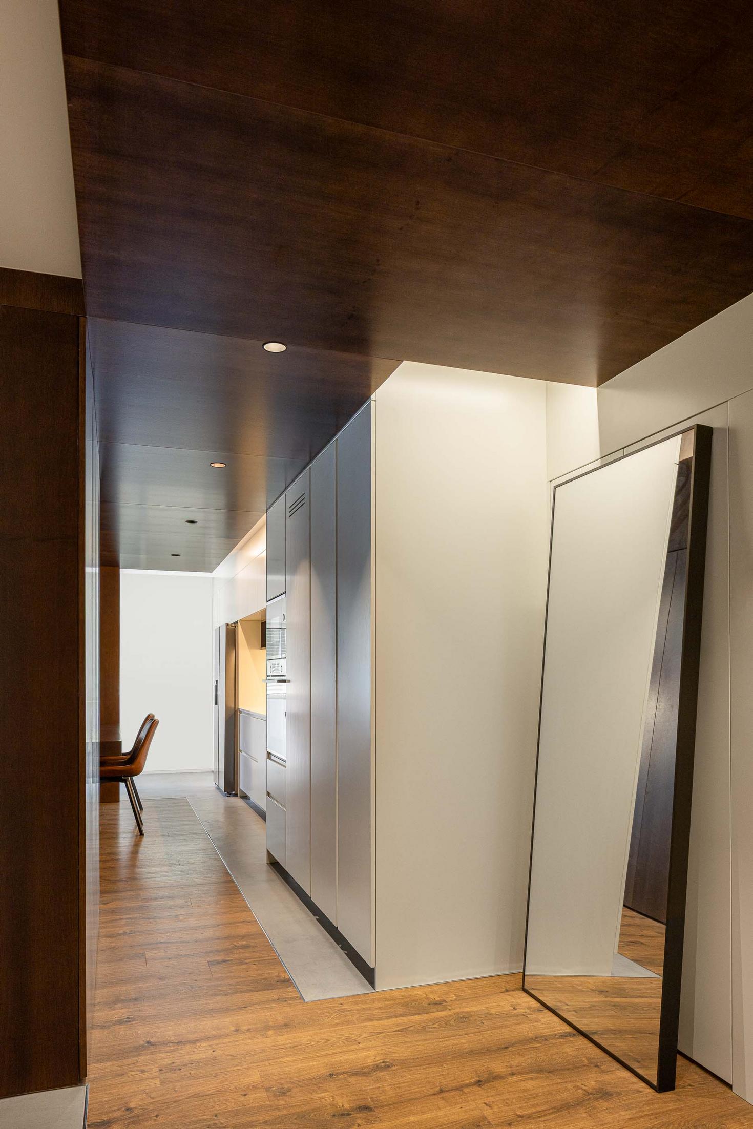 Corredor: Espelho comprido. Pavimento em madeira e cimento. — APARTAMENTO FP arquitetura ArquitectosRT em Braga