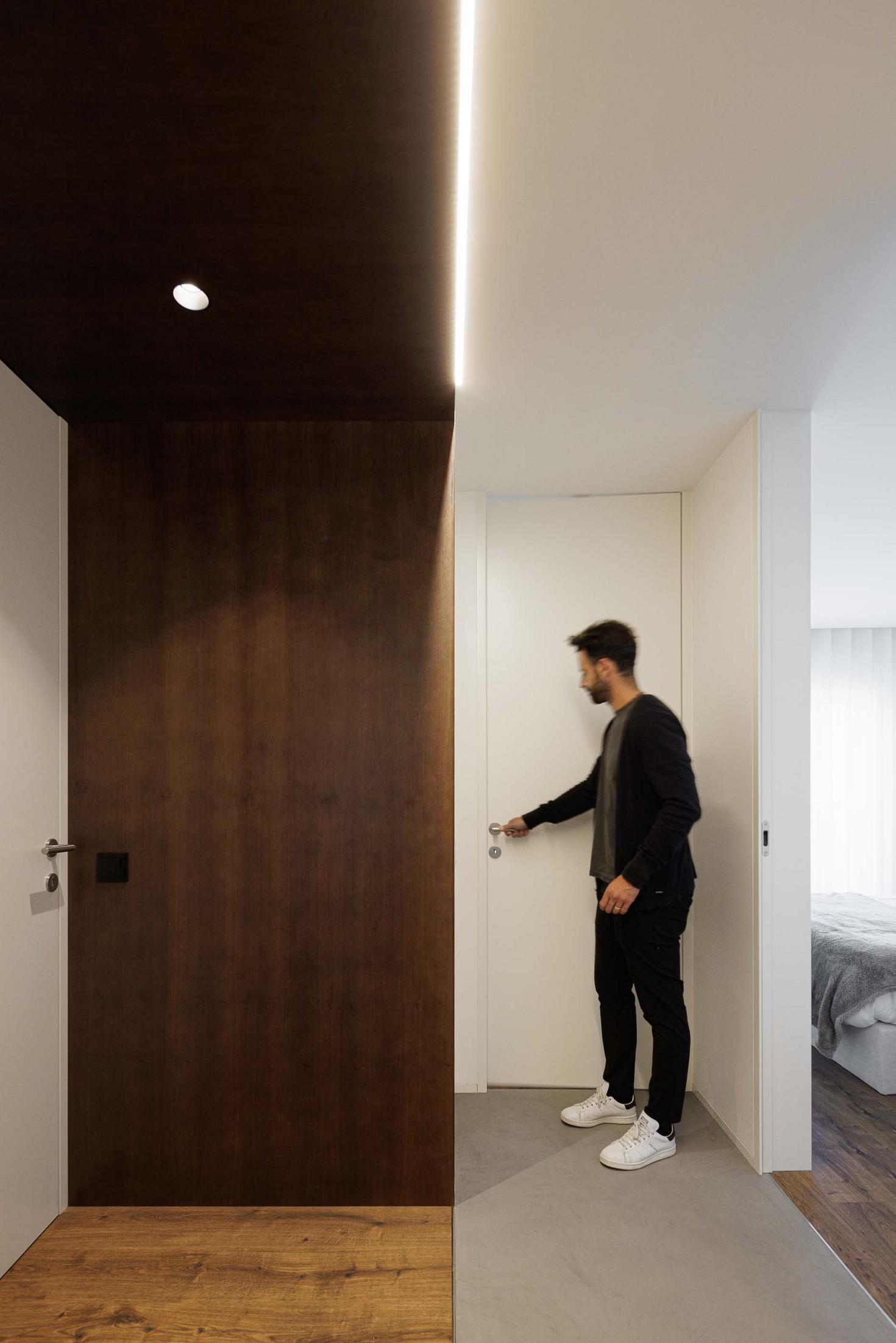 Hall de entrada: Porta para quarto. Pavimento em madeira e cimento. — APARTAMENTO FP arquitetura ArquitectosRT em Braga