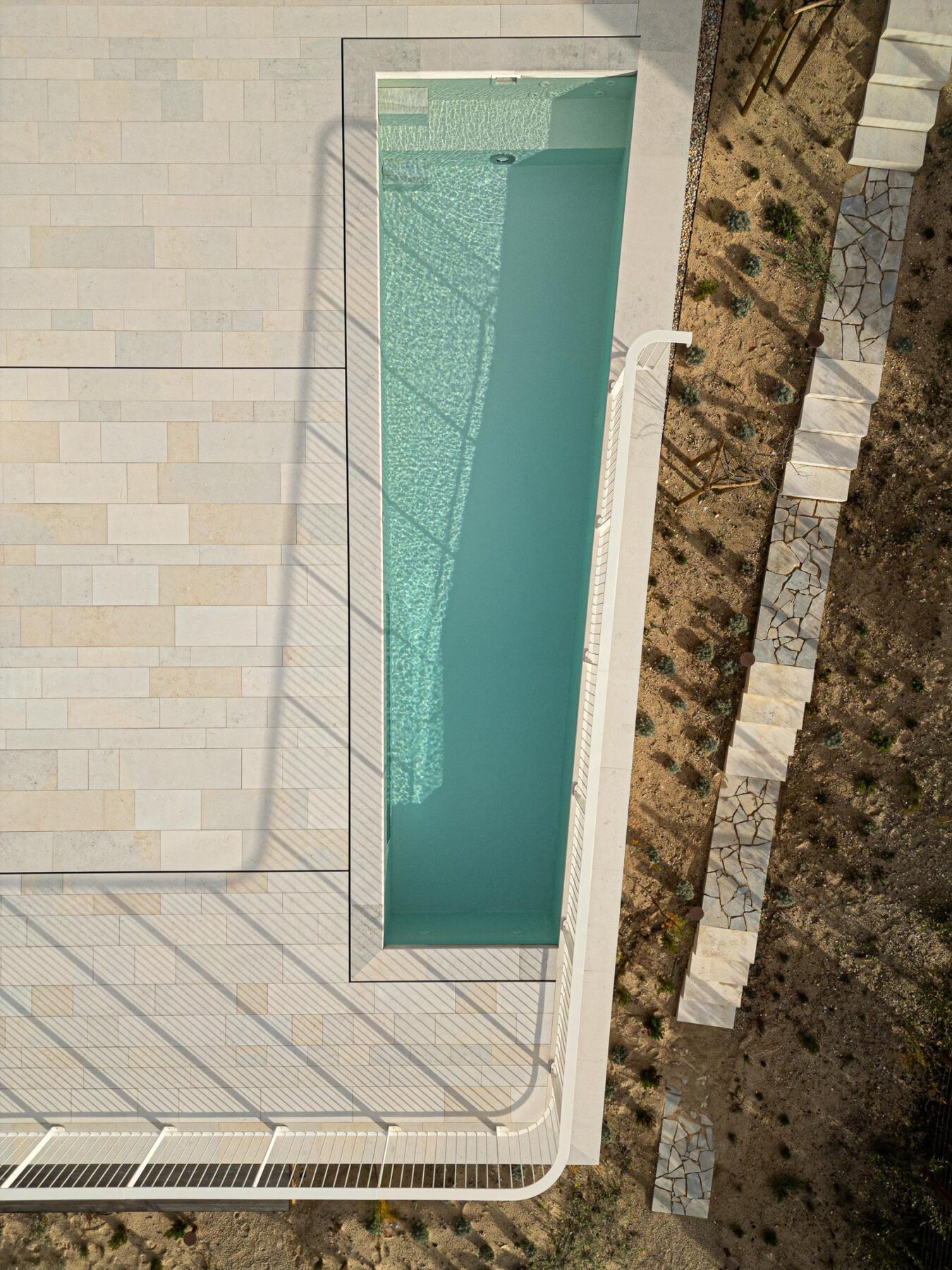 Piscina: Vista aérea da piscina retangular com pavimento em pedra e jardim. — WEST CLIFFS D45 arquitetura ARX Portugal - Arquitectos em Óbidos