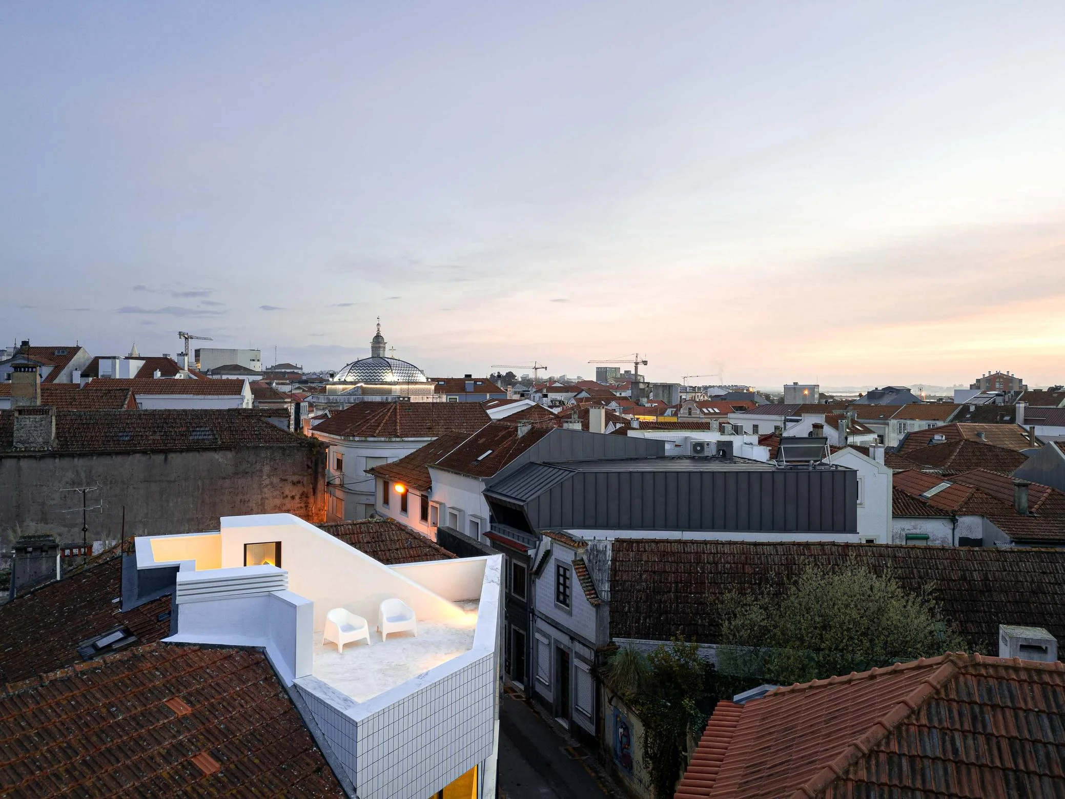 Cobertura: Vista da cobertura com terra&ccedil;o e cadeiras, inserida no contexto urbano de Aveiro. &mdash; Beira Mar II arquitetura Paulo Martins Arquitectura e Design em Aveiro