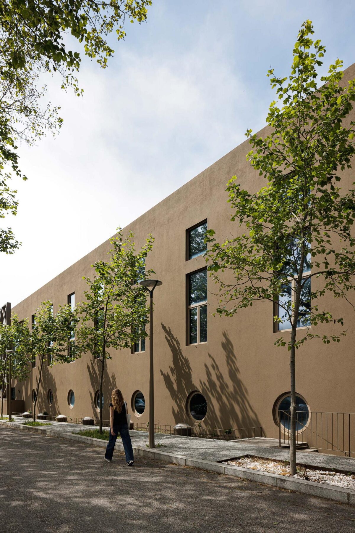 Exterior: Fachada lateral do edifício com janelas retangulares e circulares. — Assembleia da Granja arquitetura Lousinha Arquitectos em Vila Nova de Gaia