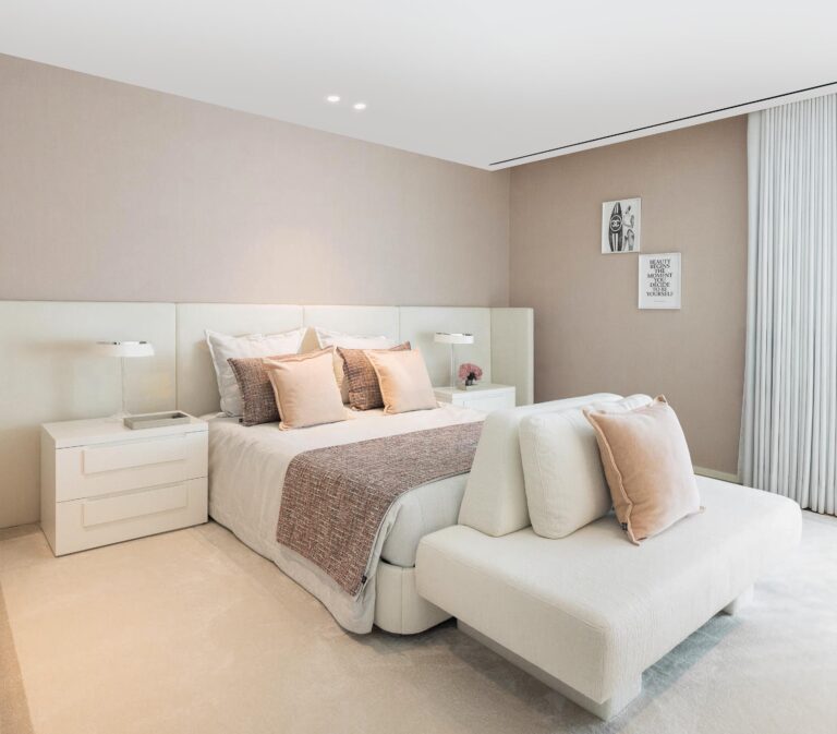 Quarto com paredes em tom neutro, cama com cabeceira branca e pavimento em alcatifa clara — Casa FJ arquitectura MIL870 + GRAUON fotografia Ivo Tavares